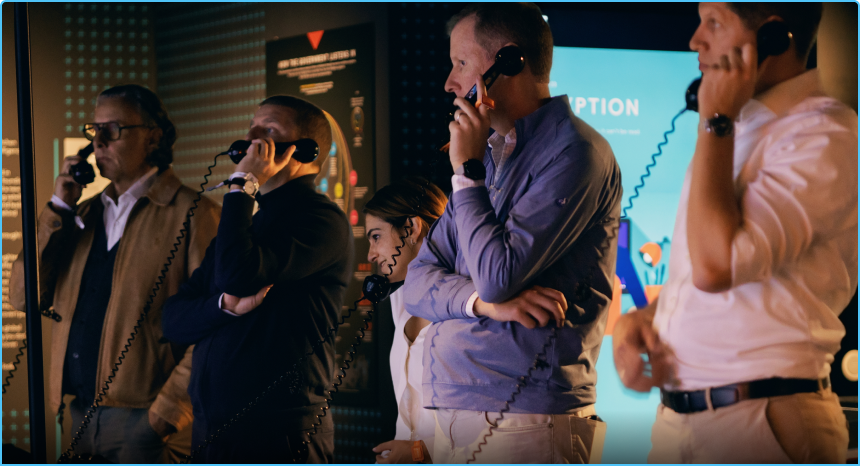Team members using retro telephones during a live challenge in the SPYSCAPE experience