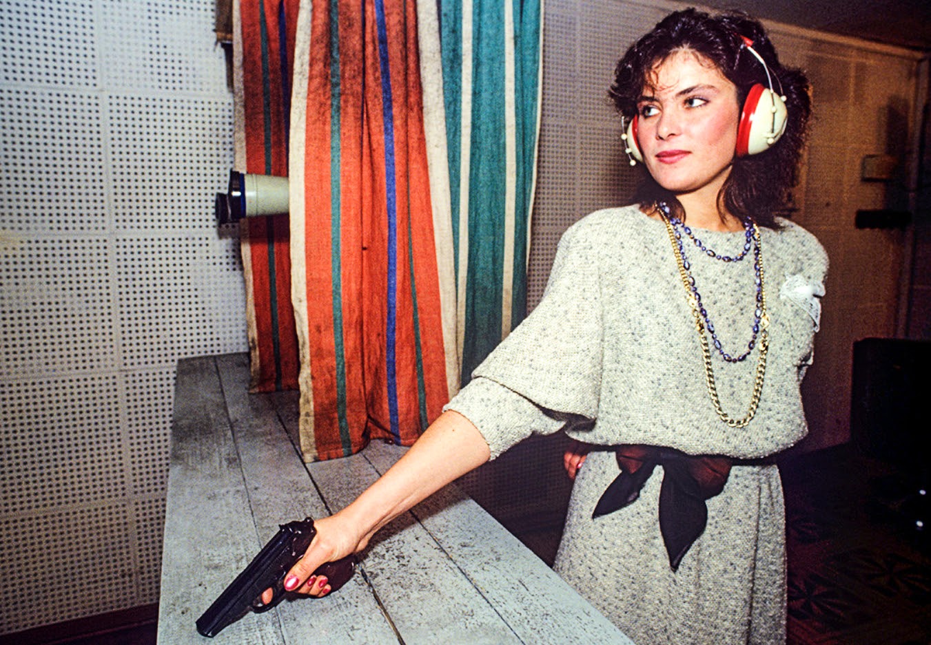Miss KGB 1990, Katya Mayorova practices with a gun