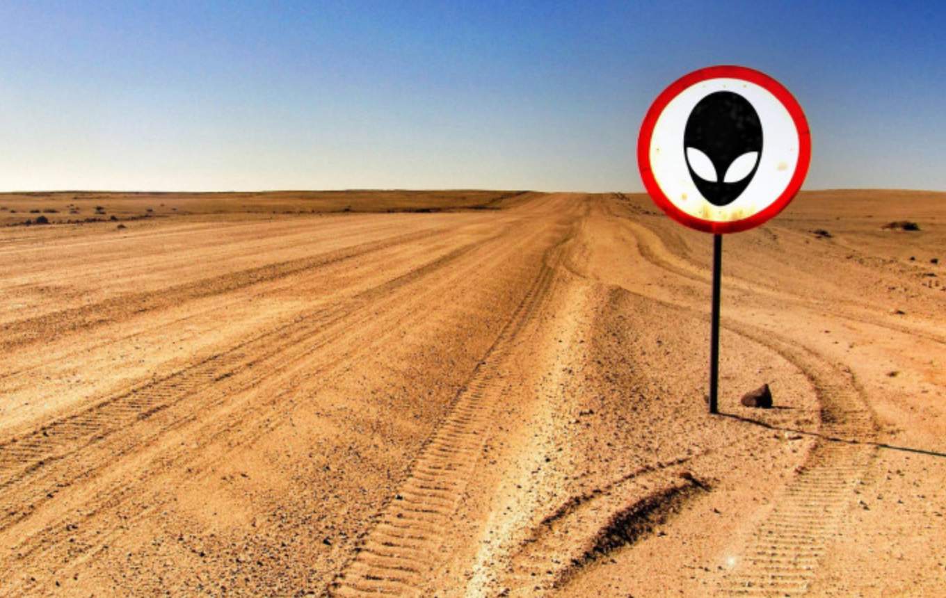 Alien station sign in the middle of the desert