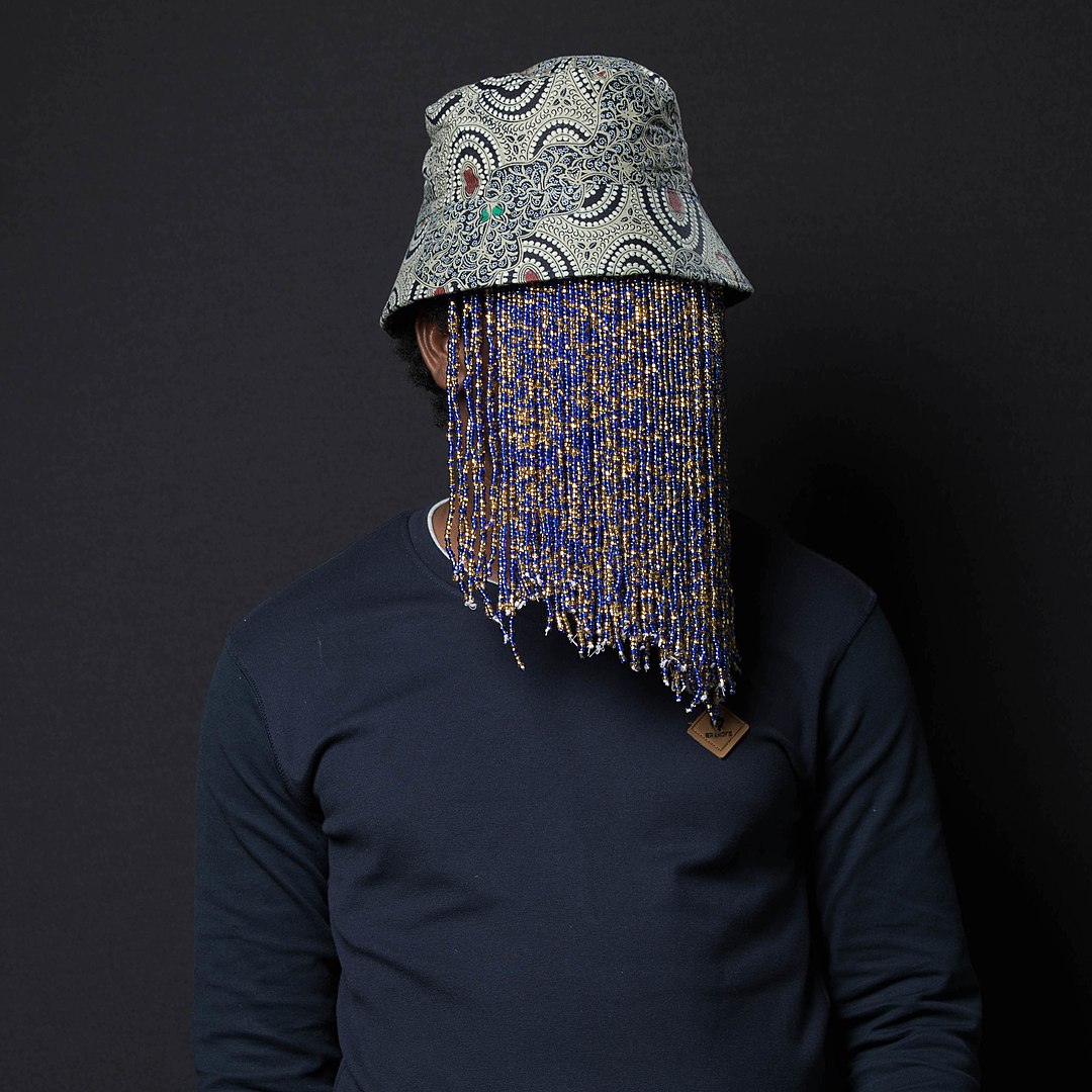 Anas Aremeyaw hides his face beneath beads because the journalist's life is in danger