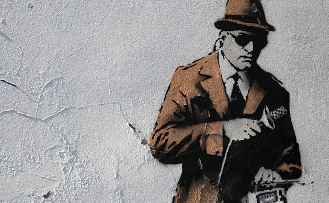 Spies and Journalists - Banksy mural of a spy in action
