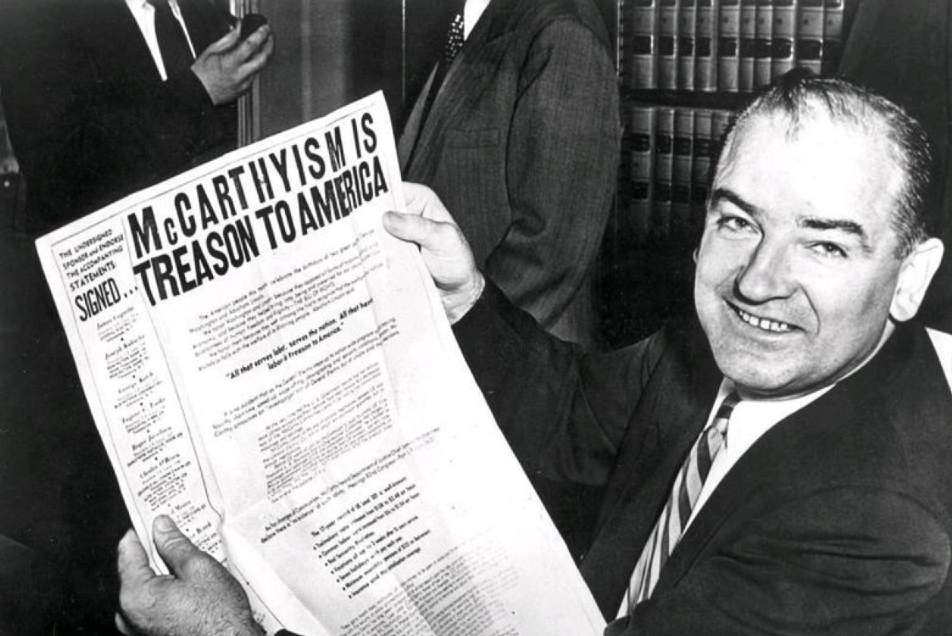 Senator McCarthy reads a newspaper about McCarthyism