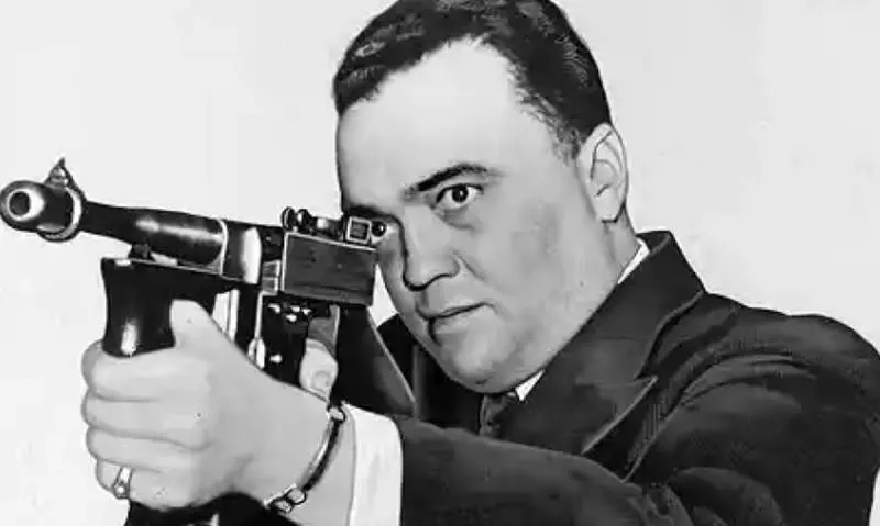 J. Edgar Hoover, former FBI chief, fires a gun