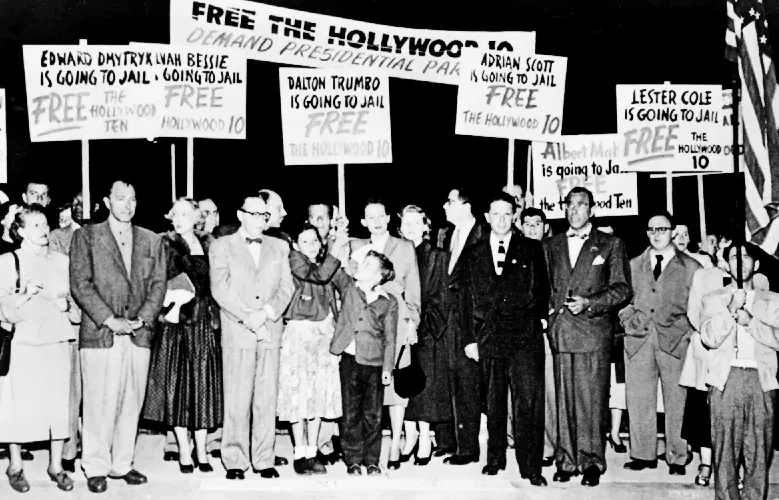 Protesters with signs saying 'Free the Hollywood 10'