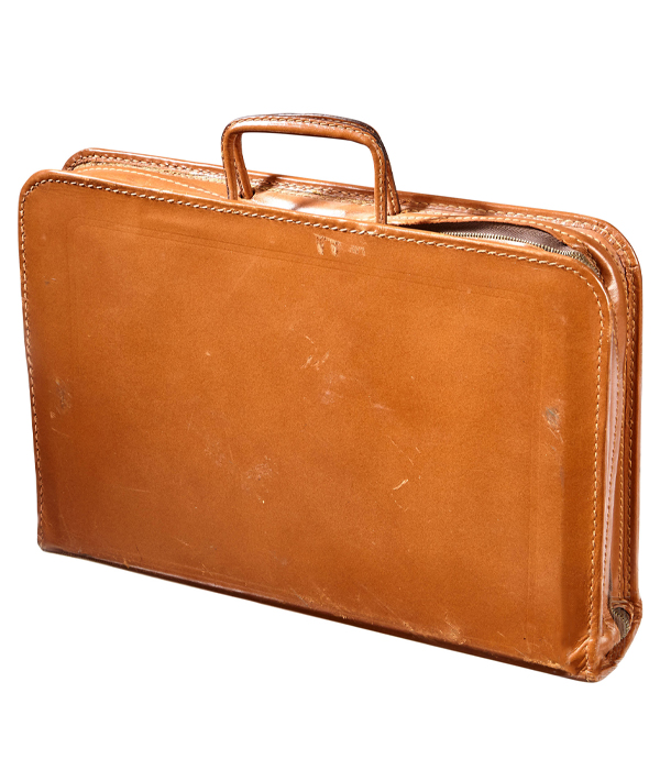 This armored briefcase was used by an agent serving in the CIA. The leather is inset with metal armor, and the whole case can be fully unzipped for use as a portable bullet-proof shield in case of an attack.