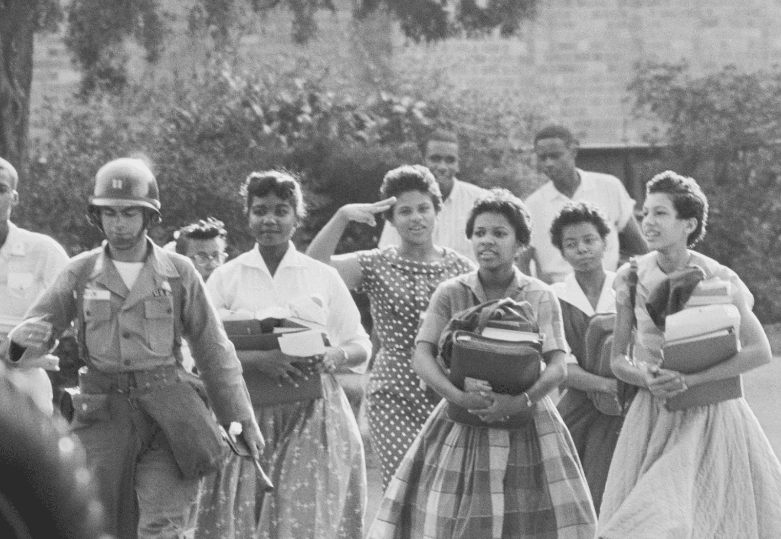 The Little Rock Nine being escorted to school in 1957